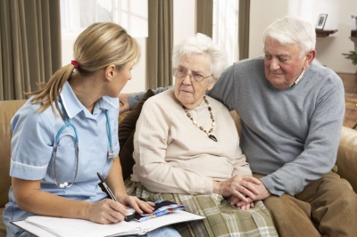 Senior couple learning about the high cost of assisted living.