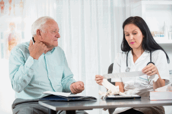 Senior man talking to doctor